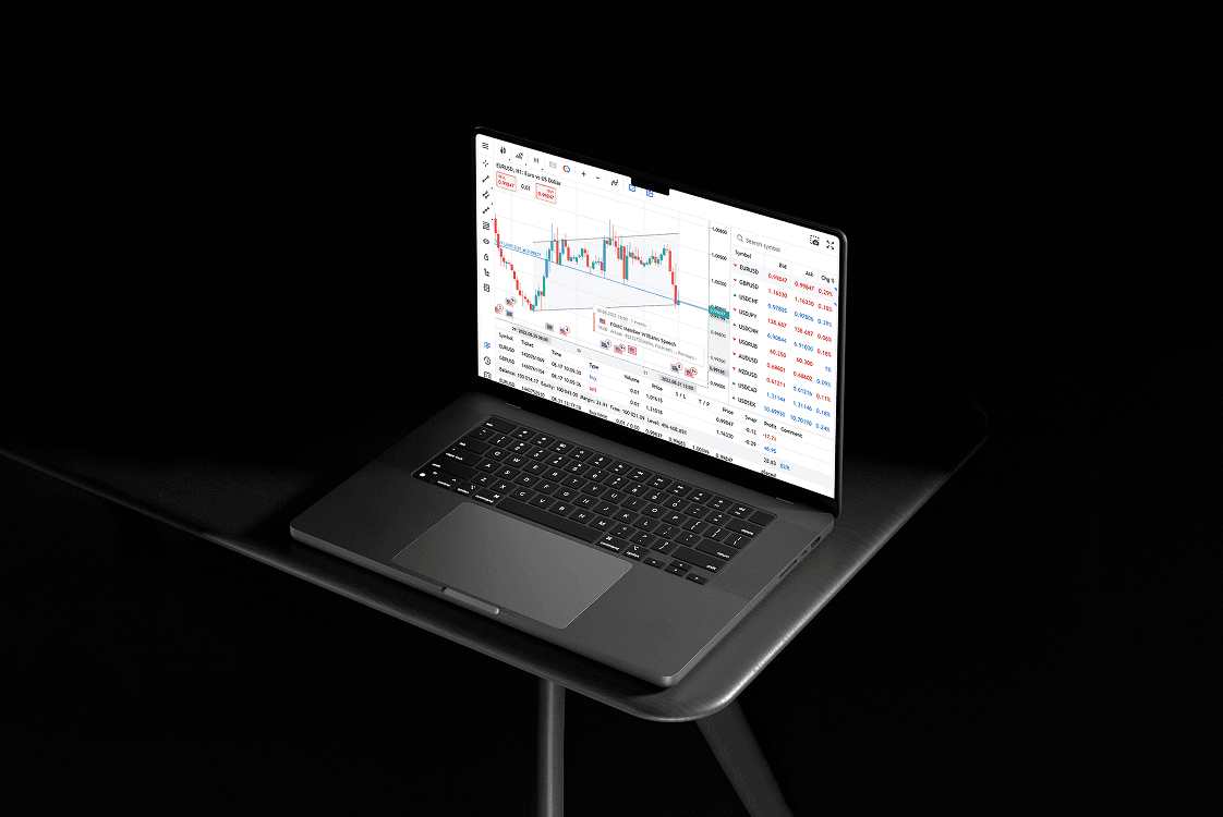 Macbook on a stool showing stock market charts
