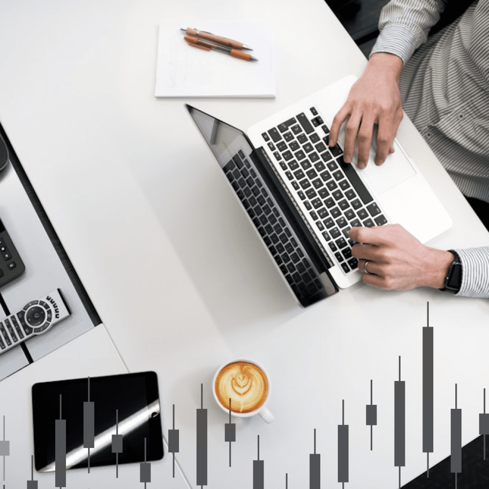 Man typing on a laptop placed on a table